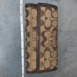 Used Coach brown and beige wallet.